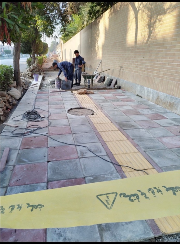 The start of the paving of the sidewalk of Enghelab St